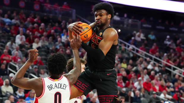 Southern California Trojans guard Bronny James (6) pulls down a defensive rebound from Arizona Wildcats guard Jaden Bradley (0) during the first half at T-Mobile Arena in Las Vegas on March 14, 2024.